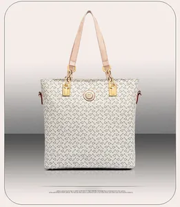 Front detail of beige leather tote bag featuring geometric equestrian patterns and gold logo