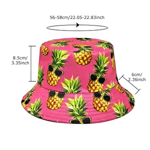 Bright pink bucket hat with pineapple print and size chart showing 56-58cm dimensions