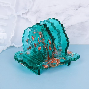 Detail view of five-piece set irregular blue resin coasters with gold foil and holder