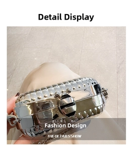 Macro shot of silver metallic party clutch with wavy texture and fine chain strap detail