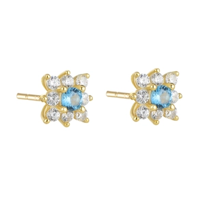Detail of gold floral stud earrings with a blue gemstone center and white zircon accents