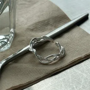 Detailed view of 925 sterling silver twisted open ring on aesthetic background