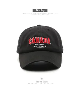 Close-up of red 3D embroidery Canada text on black washed cotton baseball cap