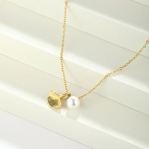Elegant gold ginkgo leaf necklace with a white pearl pendant for women fashion