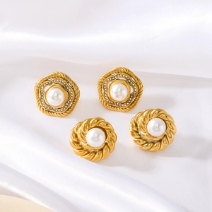 Vintage gold stud earrings with large pearls and sparkling zircons on white silk