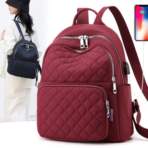 Detail view of water-resistant quilted travel bag with integrated USB charging port