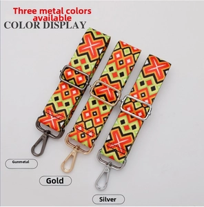 Detailed view of wide woven ethnic style straps with gunmetal, gold, and silver buckles