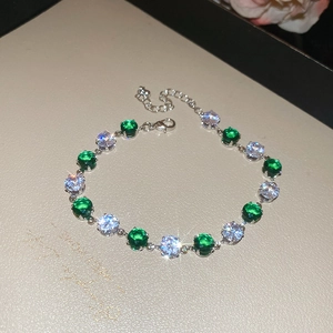 Close-up of green and white zircon bracelet with adjustable silver chain and lobster clasp