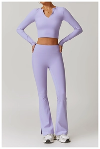 Detail of lavender yoga set showing V-neck long sleeve crop top and flared leggings