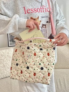 Quilted cartoon shoulder bag with festive patterns and adjustable pink strap