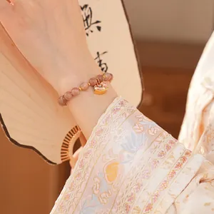 Natural sunstone beaded bracelet with golden rocking horse pendant in elegant style