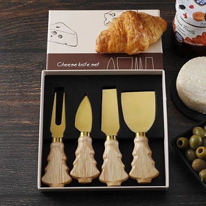 Golden cheese knife set with Christmas tree wooden handles in a gift box packaging