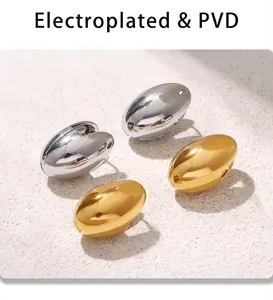 Macro detail of oval hoop earrings in gold and silver finish with PVD plating