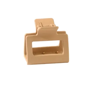 Detail view of the matte beige square hair claw clip with a strong metal spring mechanism