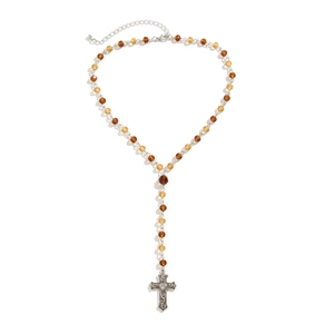 Detailed view of amber faceted beads and a vintage silver cross pendant with heart detail