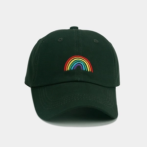 Close-up of rainbow embroidery on deep green cotton twill baseball cap with curved brim