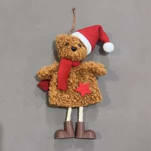 Detail of Christmas teddy bear ornament with red scarf, star decor, and long rope legs