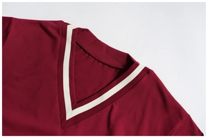 Close-up of a V-neckline with white striped ribbing on a burgundy sweatshirt