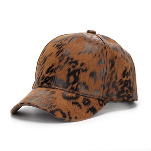 Detail view of bold leopard print baseball cap featuring textured fabric and curved brim