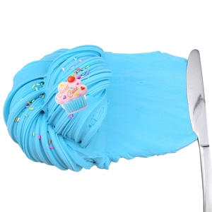 Spreading blue butter slime texture with Sweet Cake charm and colorful sprinkles