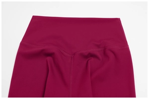 Detail of high-waist yoga leggings featuring a V-shaped back seam and brushed fabric texture