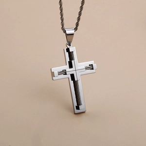 Close-up of silver stainless steel cross pendant with detailed steel wire texture design