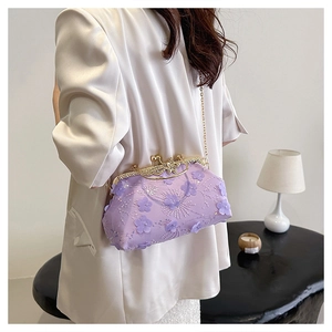 Detail of purple lace evening bag with 3D fabric flowers and golden metal chain