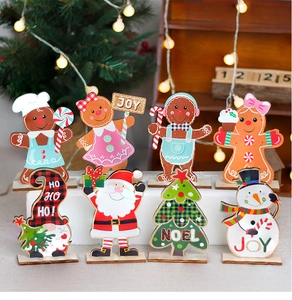 Close-up of wooden Christmas ornaments featuring Gingerbread man and Santa Claus designs