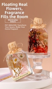 Detail of floral reed diffuser bottles with dried flowers and vintage paper wrapping