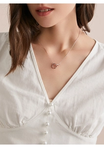 Close-up of rose gold interlocking double ring necklace with micro-pave cubic zirconia