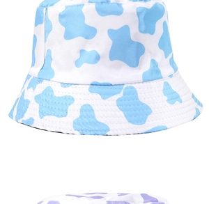 Close-up of sky blue and light purple cow print reversible cotton bucket hats