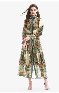 Full-body shot of lantern sleeve paisley print maxi dress with high neck and waist belt