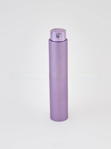 Close-up of a purple matte metal refillable perfume atomizer with a fine spray nozzle