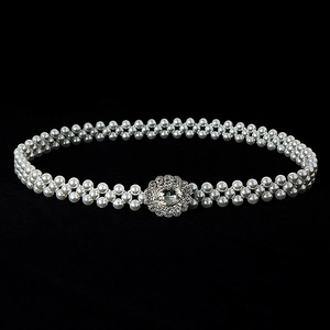 Detailed view of double-layer pearl waist chain with sparkling floral rhinestone buckle