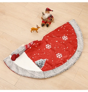 Detailed top view of burlap Christmas tree skirt with snowflake and tree patterns