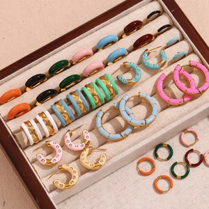 Collection of colorful enamel and gold-plated earrings in a luxury jewelry display box