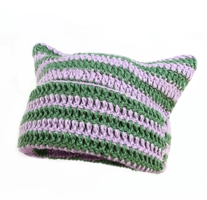 Detail of handmade purple and green striped knit cat ear hat with crochet texture
