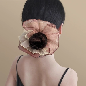 Detailed texture of multilayer chiffon scrunchie in rose pink for elegant bun styling