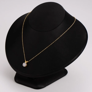 Elegant V-shaped gold necklace with round solitaire zircon pendant on black mannequin