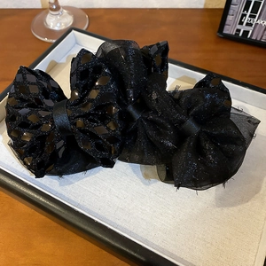Elegant black lace bow hair clips set featuring sequined fabric and mesh textures