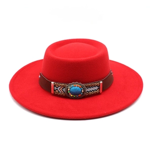 Red flat top wool felt boater hat with bohemian turquoise leather band on white background