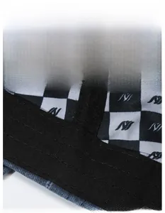 Detail of widened moisture-wicking sweatband inside a black and white checkered cap