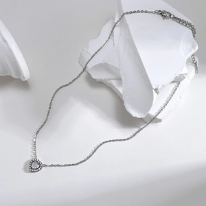 Silver stainless steel heart necklace with clear cubic zirconia on minimalist stone base