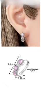 Detailed view of silver hoop earrings with triple inlaid pink and white zircons