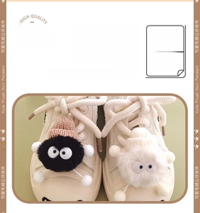 Detail of cute plush doll pendants with eyes and knit hats on white canvas sneakers