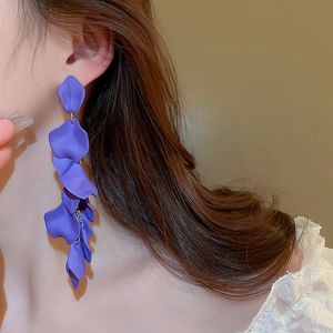 Detail of purple rose petal long tassel earrings on model with matte resin texture