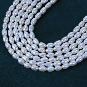 Macro view of 4-4.5mm natural freshwater rice pearls with high luster and rainbow sheen