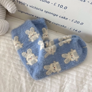 Detail of soft blue mink fleece mid-tube socks featuring a white rabbit pattern
