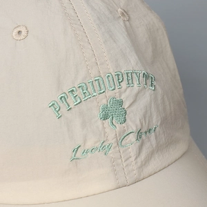 Macro detail of Lucky Clover embroidery on quick-dry breathable baseball cap