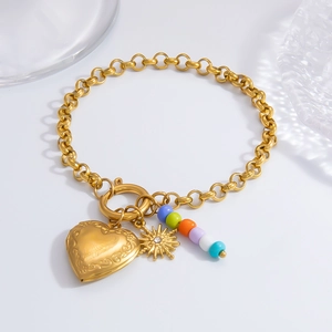 Close-up of 18K gold necklace with heart locket, sun charm and vibrant colored beads